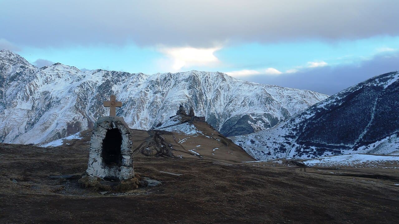 Gergeti Trinity Church with snow-capped Mount Kazbek behind